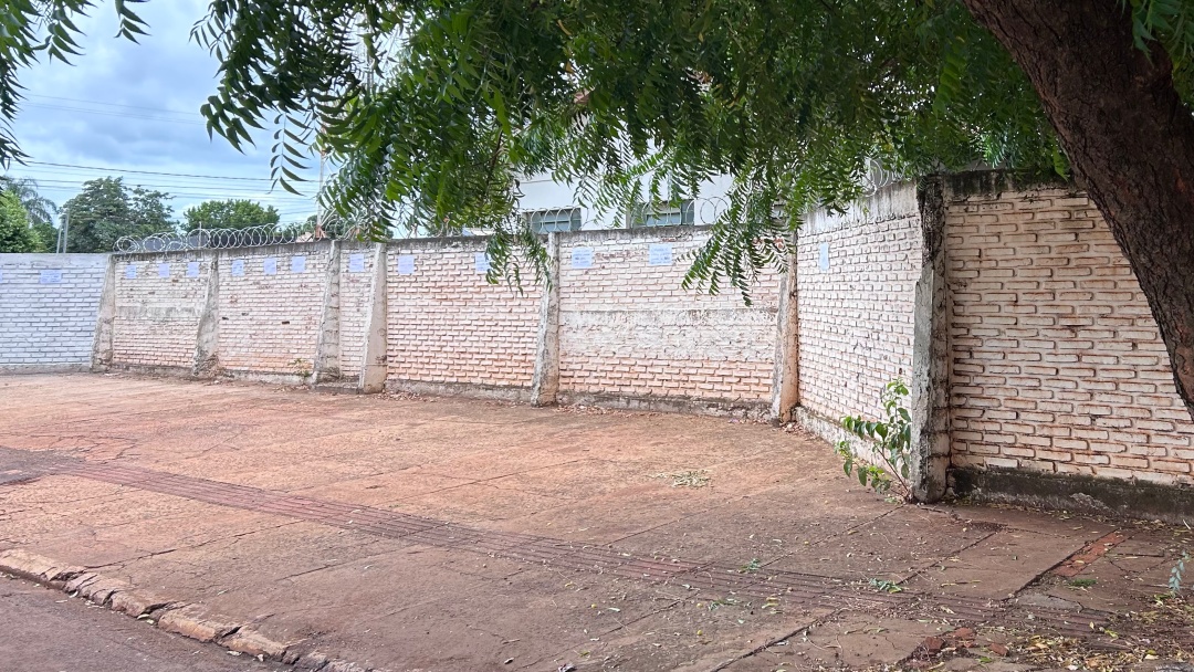 Professores pregam cartazes no muro da escola para conscientizar motoristas a n&atilde;o estacionar na cal&ccedil;ada